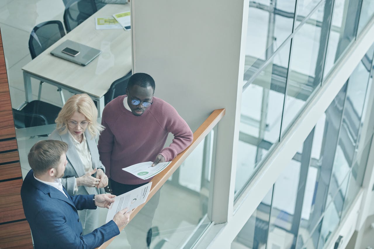 High angle view of diverse colleagues collaborating in a modern office setting.