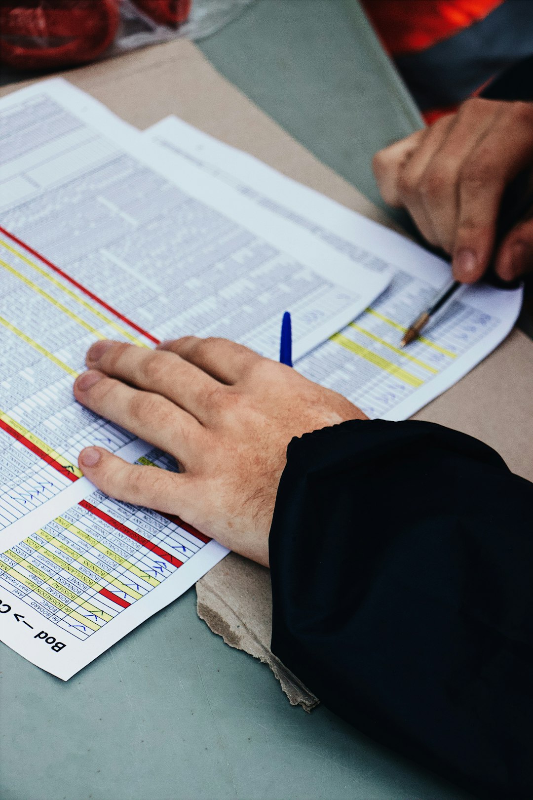 persons-hand-on-two-stack-of-paper-a7bbjzmdqk4