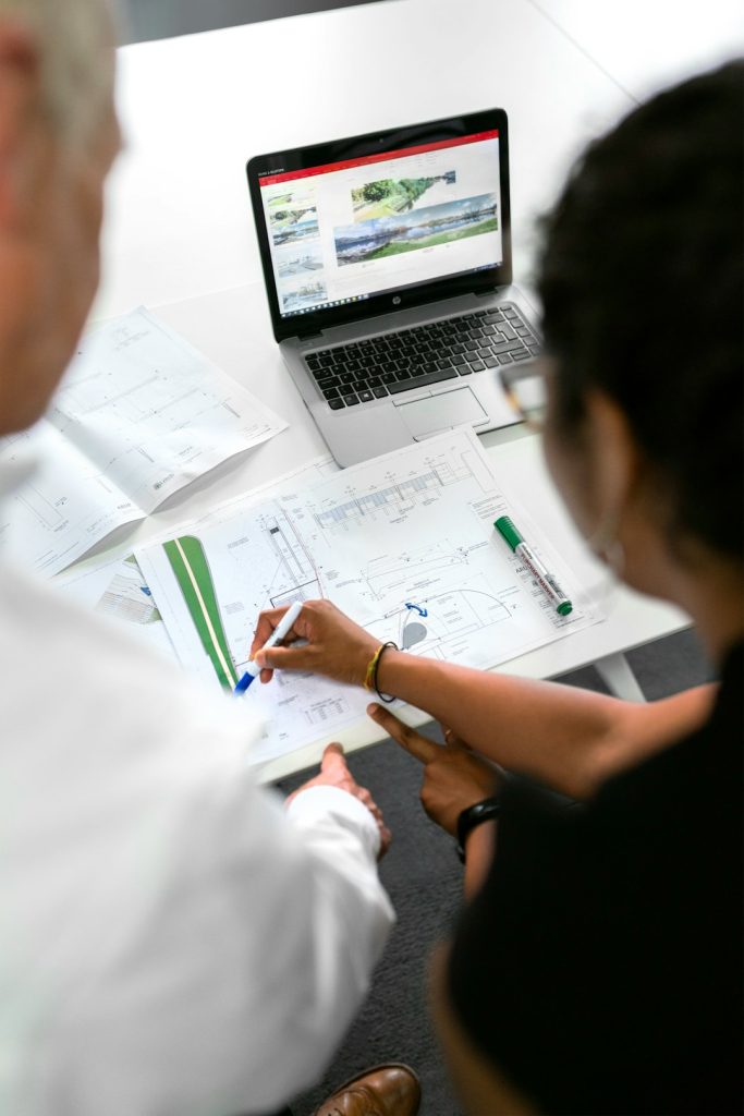 Female civil engineer discusses flood risk management plans with colleague